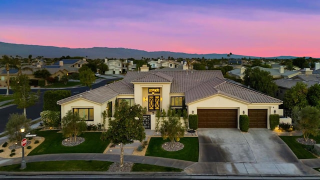 view of front of house with a mountain view and a garage