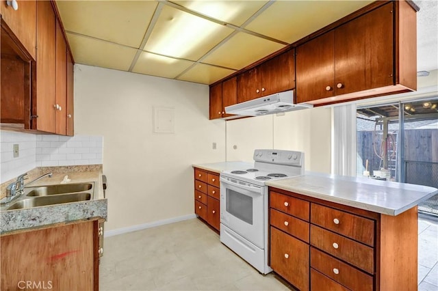 kitchen with kitchen peninsula, white range with electric cooktop, decorative backsplash, and sink