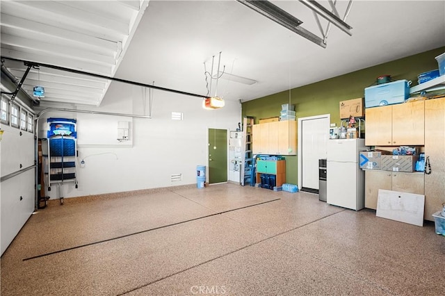 2028 Melbourne Cir, Banning, CA 92220 - garage with freestanding refrigerator and a garage door opener