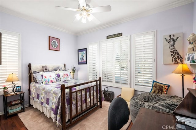 bedroom featuring ceiling fan, wood-type flooring, and crown molding