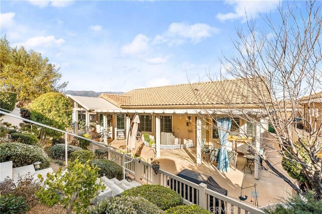2028 Melbourne Cir, Banning, CA 92220 - rear view of house with a tile roof, a patio area, and stucco siding