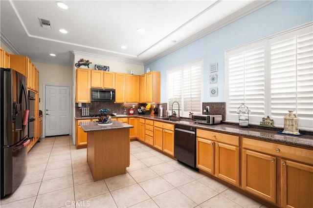 kitchen with sink, a center island, light tile patterned flooring, and black appliances