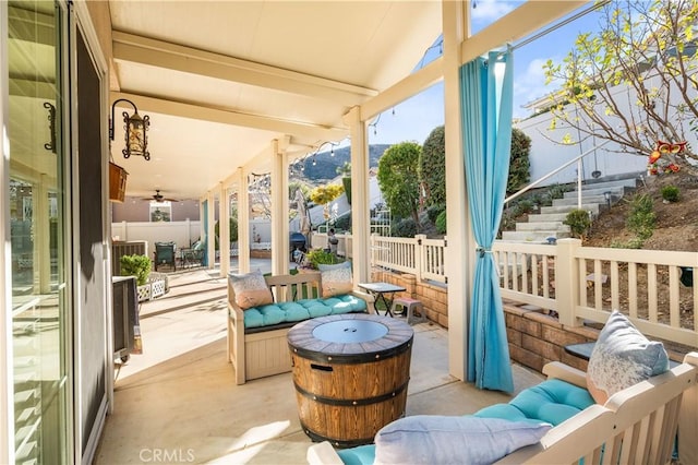 sunroom / solarium with lofted ceiling with beams and ceiling fan