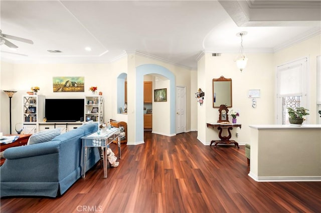 2028 Melbourne Cir, Banning, CA 92220 - living area featuring arched walkways, dark wood-type flooring, a ceiling fan, ornamental molding, and baseboards