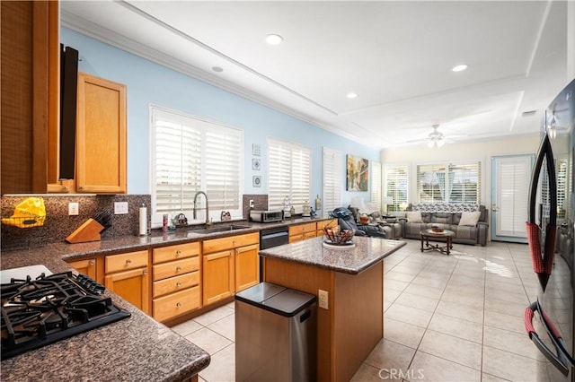 kitchen featuring a kitchen island, black gas stovetop, sink, and light tile patterned flooring