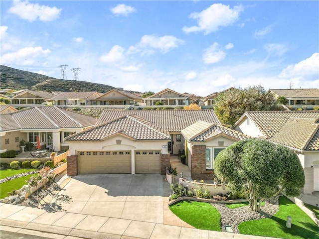2028 Melbourne Cir, Banning, CA 92220 - mediterranean / spanish-style house featuring a residential view, an attached garage, stucco siding, and driveway