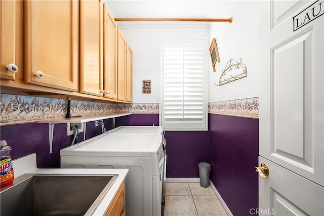 2028 Melbourne Cir, Banning, CA 92220 - laundry area featuring washer and clothes dryer, cabinet space, light tile patterned flooring, and baseboards