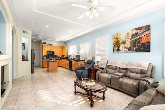 living room featuring light tile patterned floors, ceiling fan, and crown molding