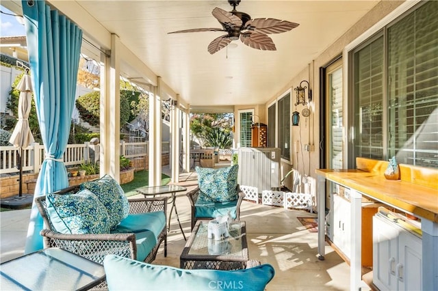 sunroom featuring ceiling fan