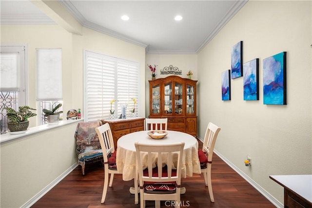 dining area with dark wood-type flooring and ornamental molding