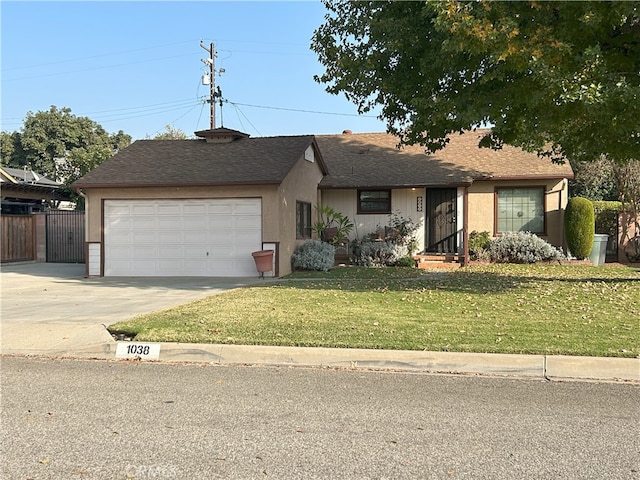 ranch-style home with a garage and a front lawn