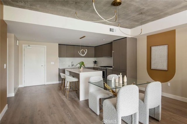 dining area featuring light wood-type flooring and sink