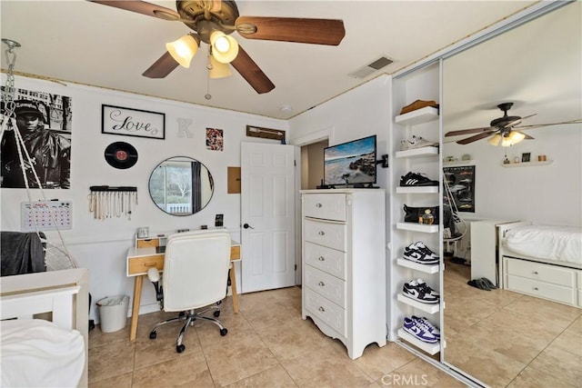 bedroom with ceiling fan and light tile patterned flooring