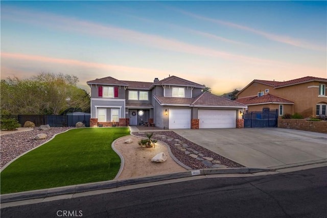 view of front of home featuring a garage and a yard