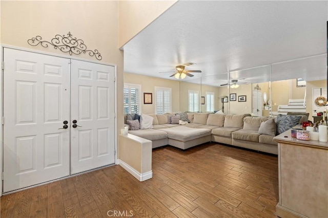 living room with hardwood / wood-style flooring and ceiling fan