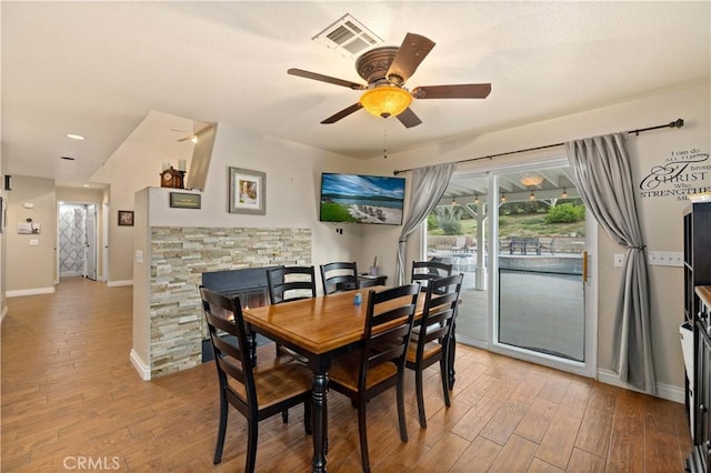 dining space with light hardwood / wood-style floors and ceiling fan