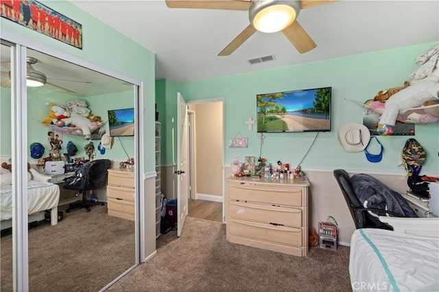 carpeted bedroom with a closet and ceiling fan