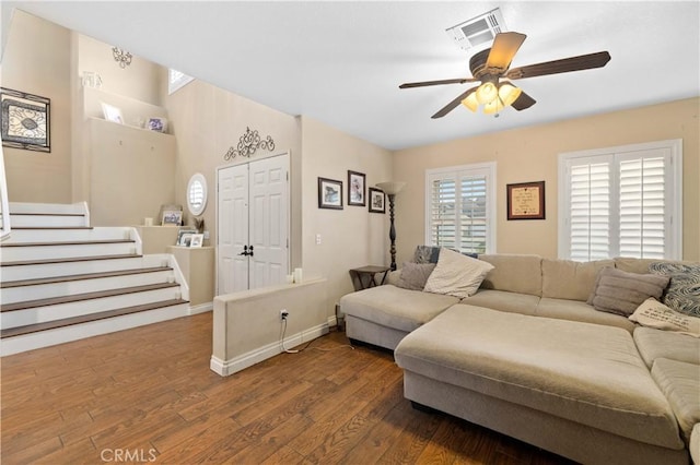 living room featuring ceiling fan and dark wood-type flooring