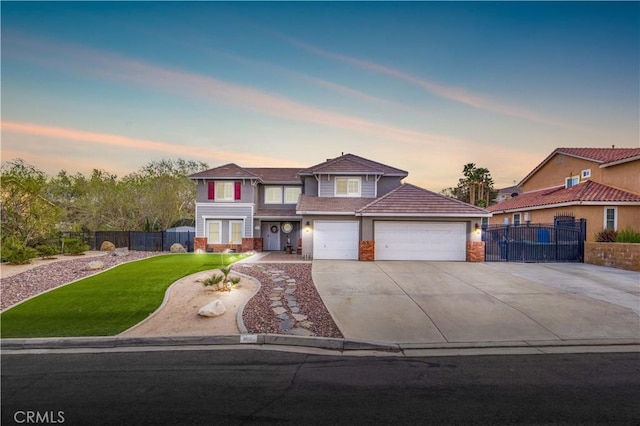 view of front of home with a garage and a yard