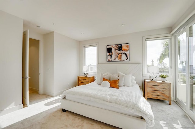 carpeted bedroom with multiple windows