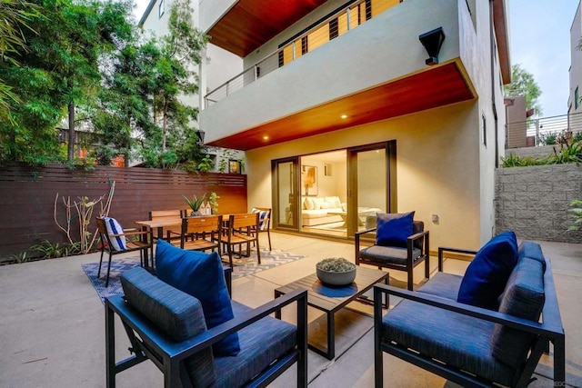 view of patio featuring an outdoor living space and a balcony