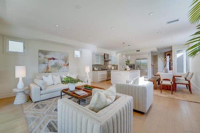 living room featuring light hardwood / wood-style floors and sink