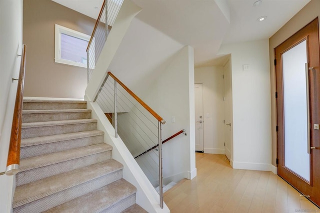 staircase featuring hardwood / wood-style floors