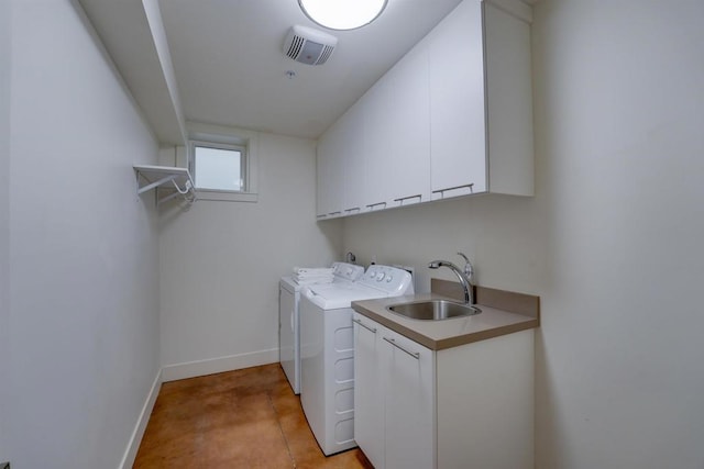 laundry room featuring washer and dryer, sink, light tile patterned flooring, and cabinets