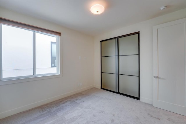 unfurnished bedroom with light colored carpet