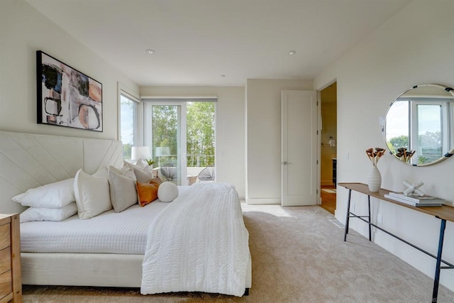 bedroom featuring multiple windows and light carpet