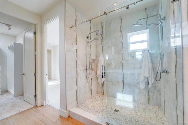 bathroom featuring hardwood / wood-style floors and an enclosed shower