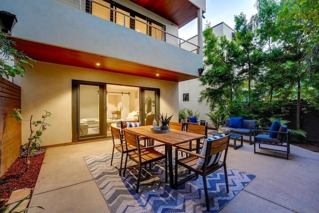 view of patio / terrace with an outdoor living space and a balcony