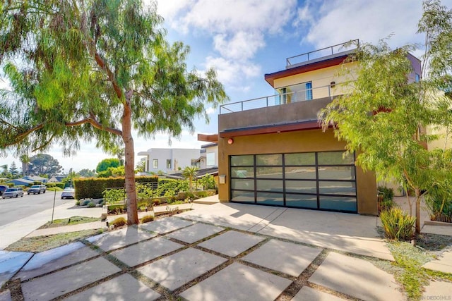 contemporary home featuring a balcony and a garage