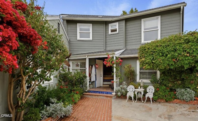 rear view of property featuring a patio area