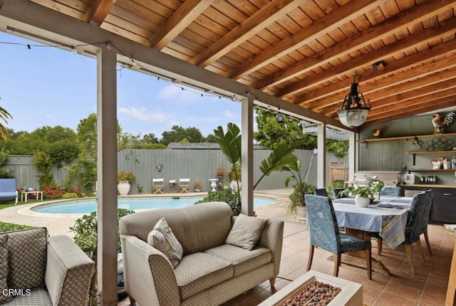 sunroom with plenty of natural light, beam ceiling, and wood ceiling