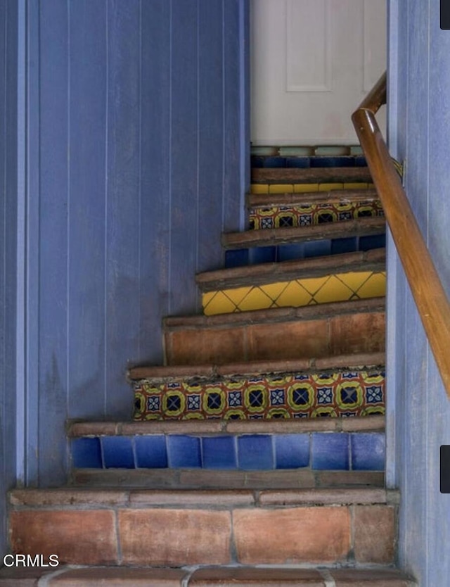 stairs with wood walls