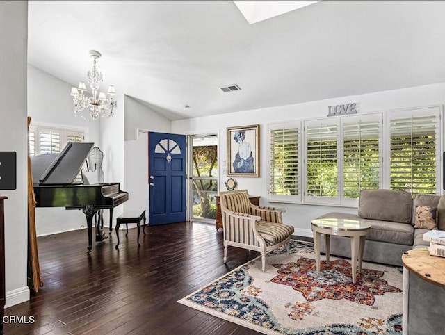 living room with dark hardwood / wood-style flooring, lofted ceiling, and a chandelier