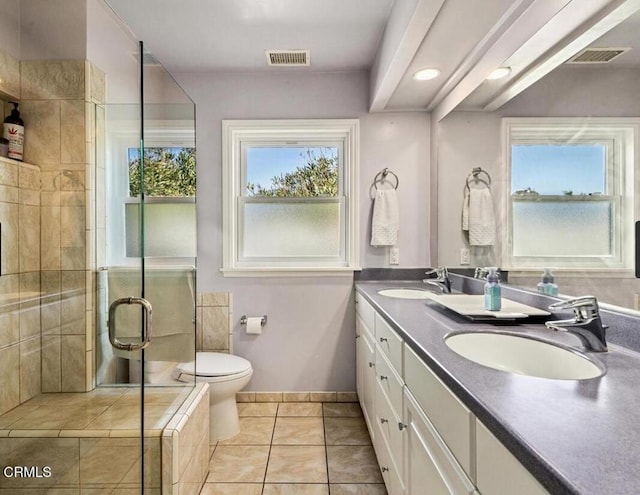 bathroom with tile patterned flooring, vanity, toilet, and a shower with door