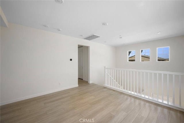 empty room with light hardwood / wood-style floors