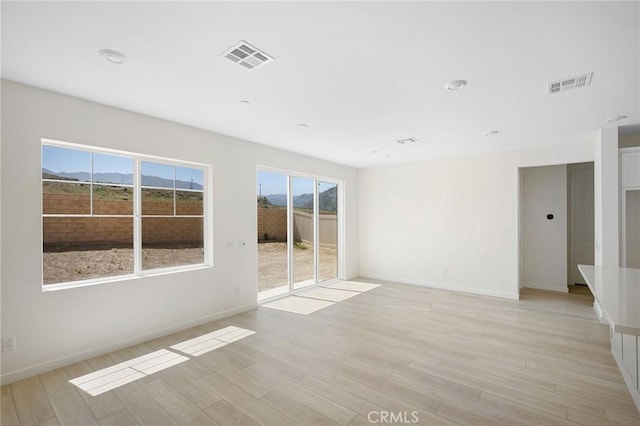 spare room featuring light wood-type flooring