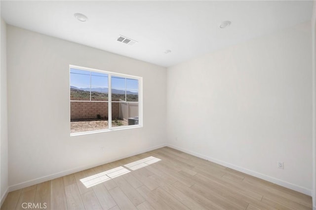 spare room featuring light wood-type flooring