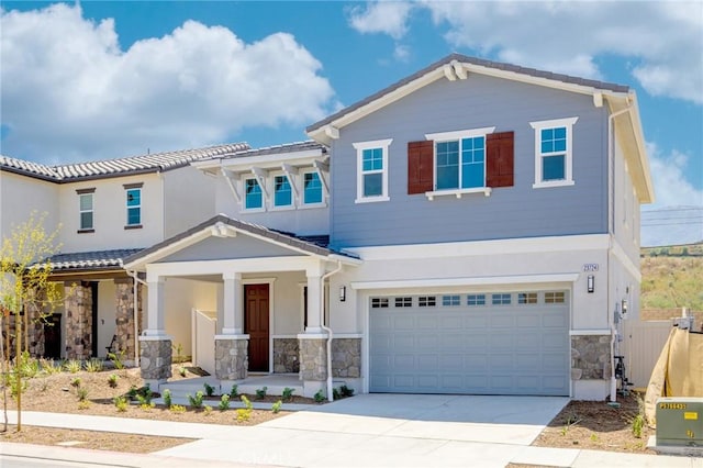23724 Wilcox Dr, Newhall, CA 91321 - view of front of house featuring stone siding, covered porch, driveway, an attached garage, and stucco siding