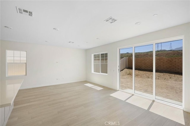 spare room with light hardwood / wood-style floors