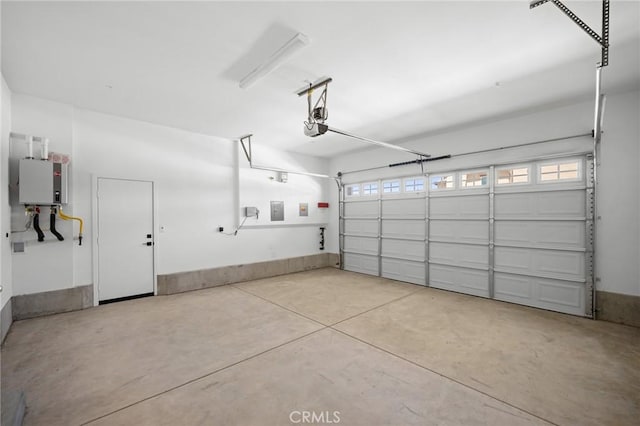 garage featuring tankless water heater and a garage door opener