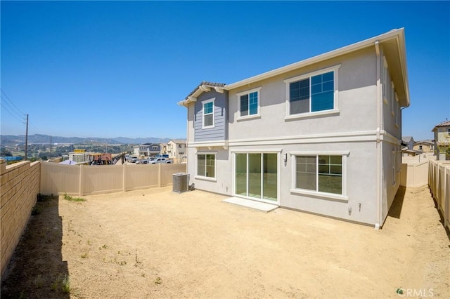 rear view of house with a mountain view and central air condition unit