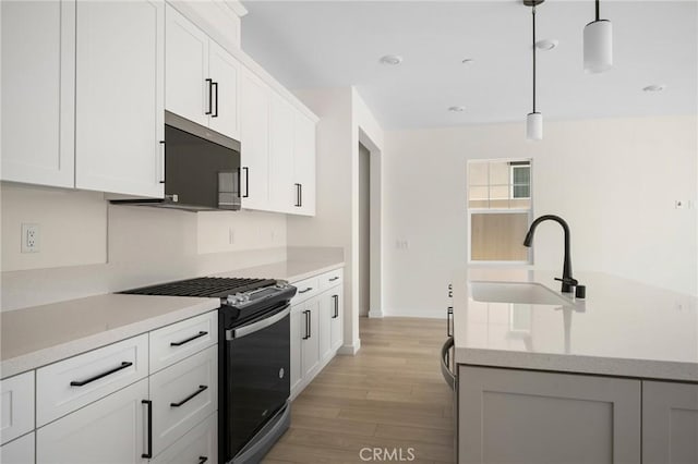 23724 Wilcox Dr, Newhall, CA 91321 - kitchen featuring appliances with stainless steel finishes, light countertops, light wood-type flooring, decorative light fixtures, and recessed lighting