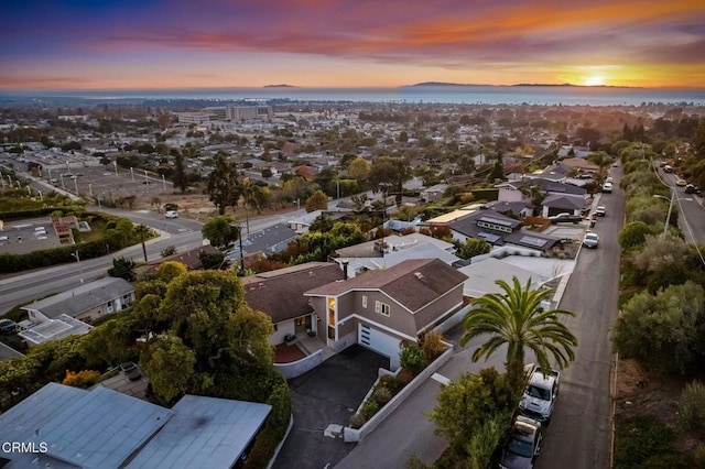 aerial view at dusk with a water view