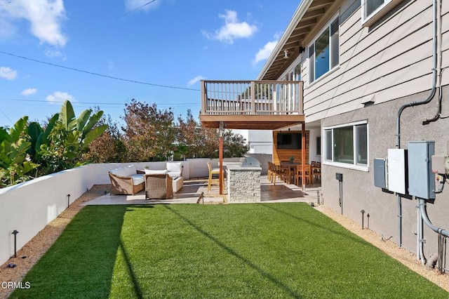 view of yard with a patio area, an outdoor kitchen, outdoor lounge area, and a fenced backyard