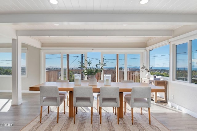 sunroom / solarium featuring beam ceiling