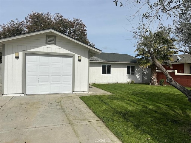 view of front of home featuring a garage, concrete driveway, and a front lawn